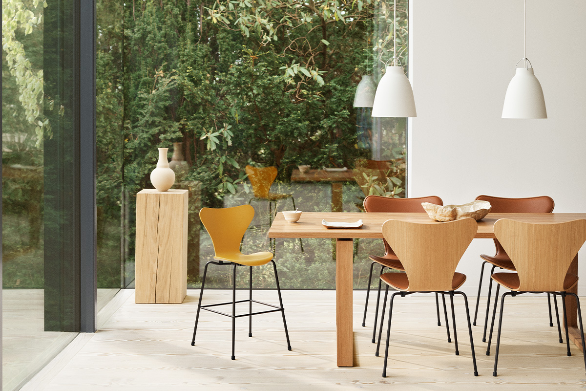 Dining scene with wooden furniture and white pendant lighting